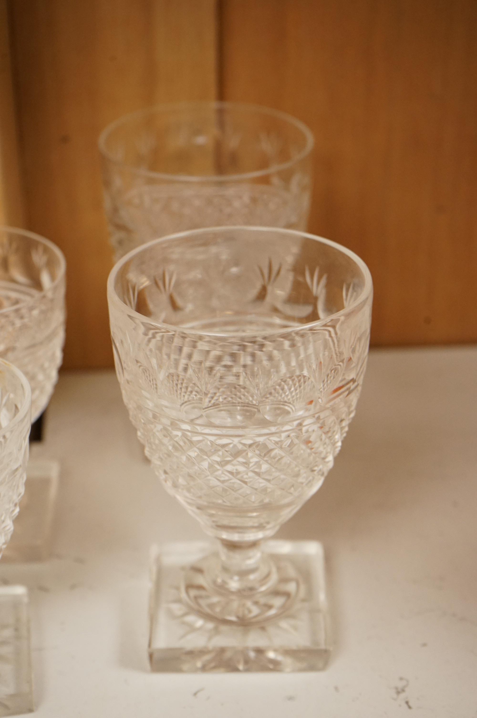 Seven Georgian style facet stem engraved wine glasses and a part suite of 19th centuy rummers, largest 14cm high